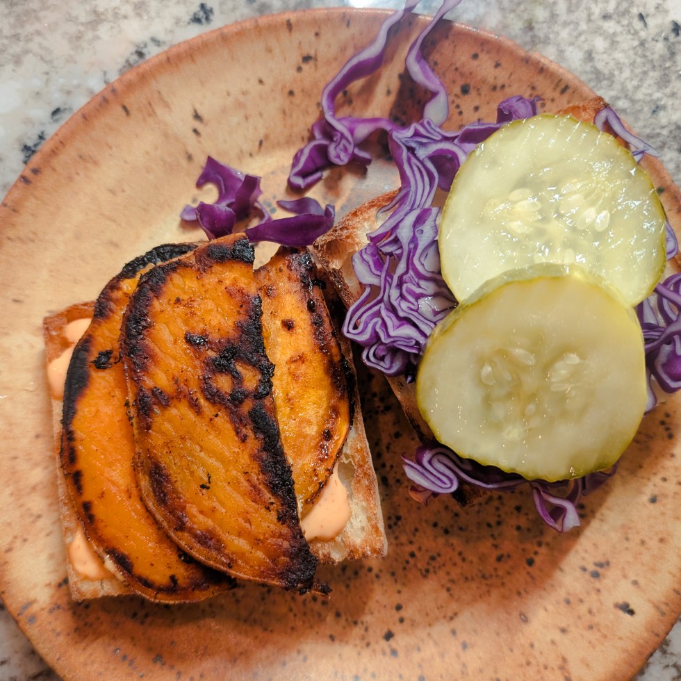 Open sweet potato pickle cabbage sandwich on a plate.